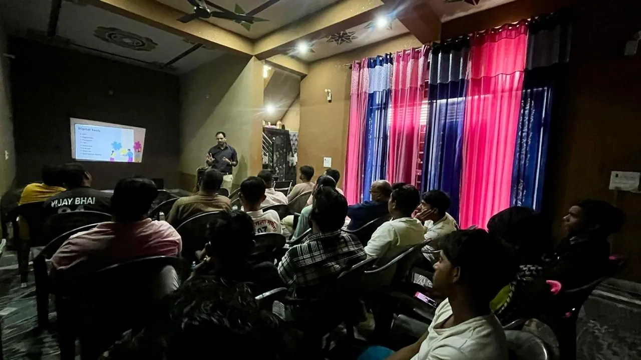 Wide view of a packed community hall during a digital-skills session